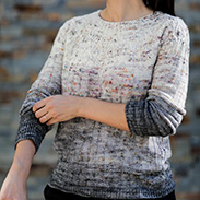 A model wearing a long sleeve grey fade speckled knit top