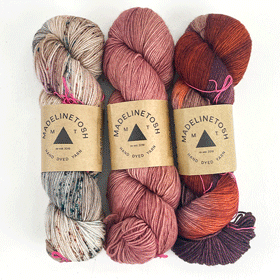 A gif of groups of 3 skeins of colorful yarn
