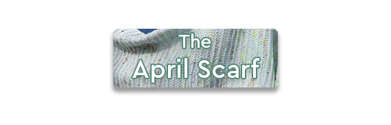 The April Scarf text over a close up shot of a knit shawl