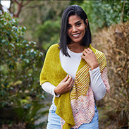 A model wearing a pink and yellow knit shawl