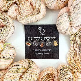 A pack of 5 stitch markers surrounded by pink speckled yarn