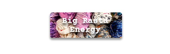 Big Rasta Energy text over a pile of different colored skeins of yarn