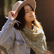 A model wearing a knit shawl