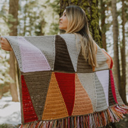 A model wearing a colorful pattern blanket