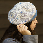 A model wearing a blue patterned beret