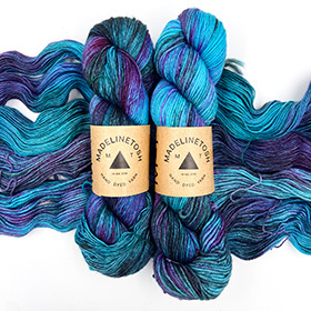 A skein of blue and purple variegated yarn