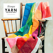 A rainbow colored blanket draped over a chair