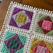 A granny square blanket with varying colors