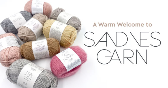 A pile of yarn next to text that reads A Warm Welcome to Sandnes Garn