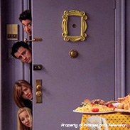 An image from the TV show Friends where they're all next to a purple door