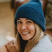 A model wearing a blue knit beanie