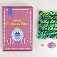 A pink box that says Jimmy's Princess Pack with an illustrated carriage and mini skeins of green variegated yarn