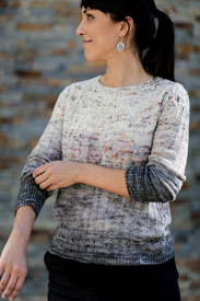 A model wearing a grey gradient sweater