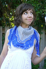 A model wearing a blue knit shawl