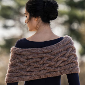 A model wearing a brown knit cowl