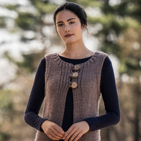 A model wearing a brown knit vest