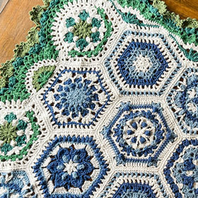 Scheepjes Scrumptious Heirloom Collection Blanket Kit - A close up shot of a knit blanket with intricate designs