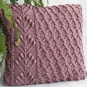 Scheepjes Scrumptious Umbella Pillow Kit - A shot of a purple knit pillow with intricate details