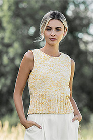 A model wearing a yellow knit tank top and white pants