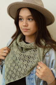 A model wearing a green knit scarf